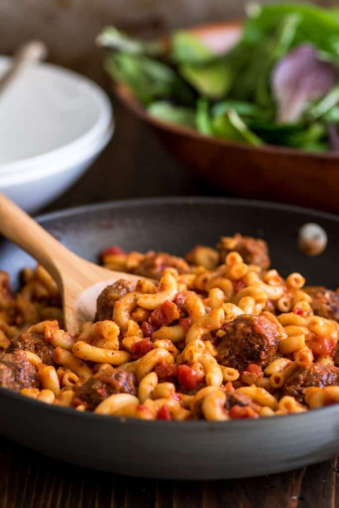 Image of Homemade Spaghettios in pot in front of salad.