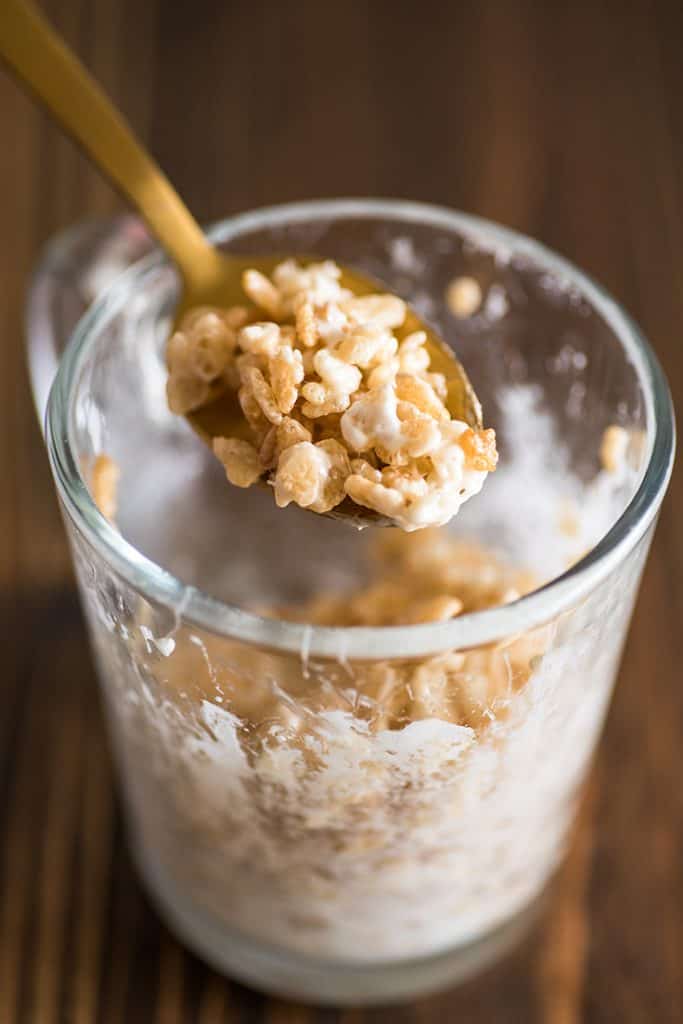 Picture of single-serve rice krispie treat in a mug being eaten with a spoon.