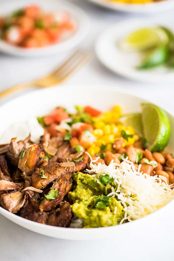 Crispy Slow Cooker Carnitas in a burrito bowl.