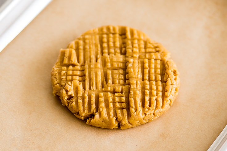 Picture of cookie dough for giant peanut butter cookie on a baking sheet.