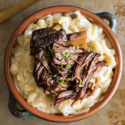 Overhead photo of Short Rib Mac and Cheese in a blue and orange bowl.