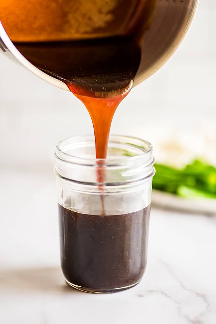 Picture of thick homemade teriyaki sauce being poured into a jar.
