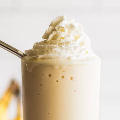 Banana milkshake in a tall glass.