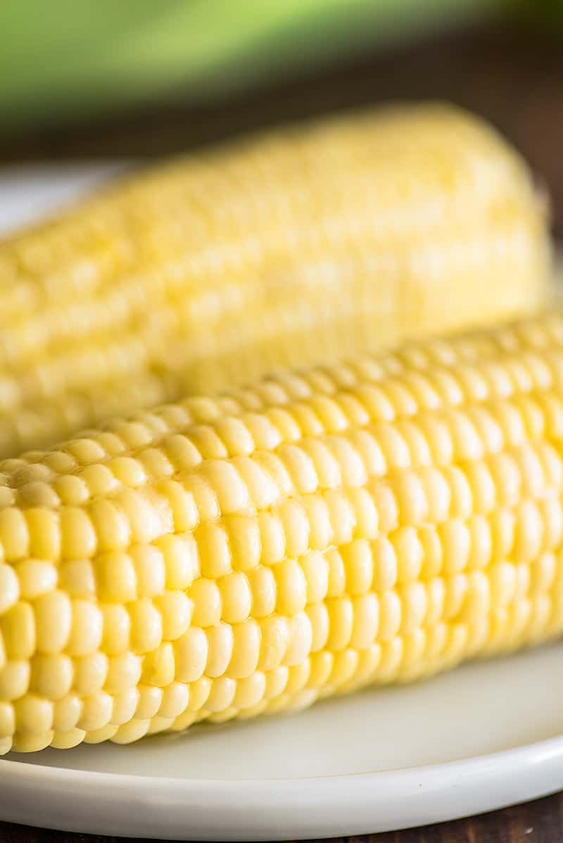 Microwave corn on the cob on a plate.