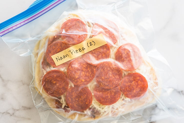 Picture of naan pizza wrapped for the freezer in a freezer bag.