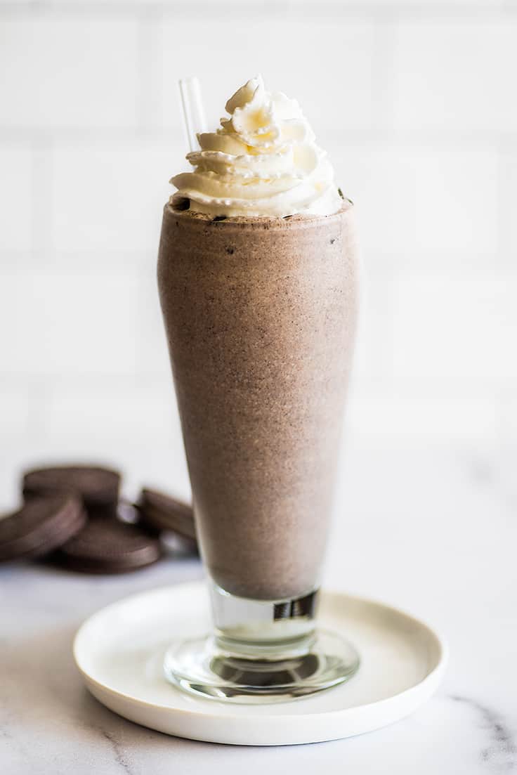 Oreo milkshake with whipped cream on top.