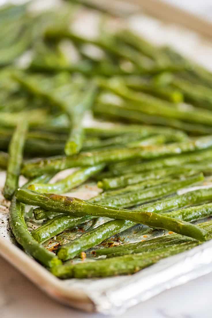 Roasted green beans on a baking sheet.
