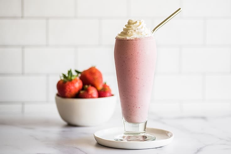 Strawberry Milkshake in a tall glass.