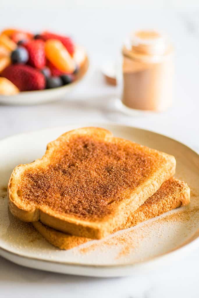 Photo of cinnamon sugar toast on a white plate.