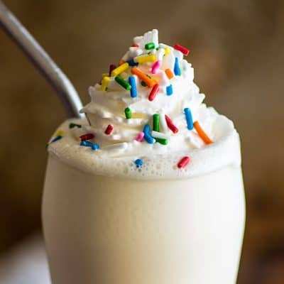 Milkshake with whipped cream and sprinkles.