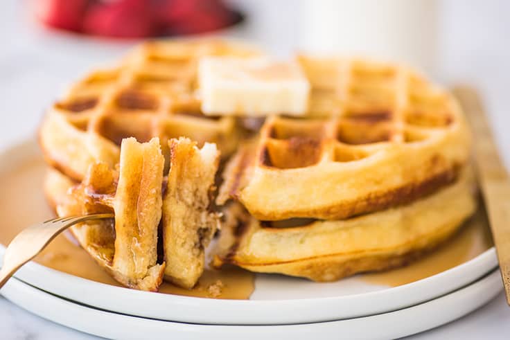 Pieces of crispy waffles on a fork.