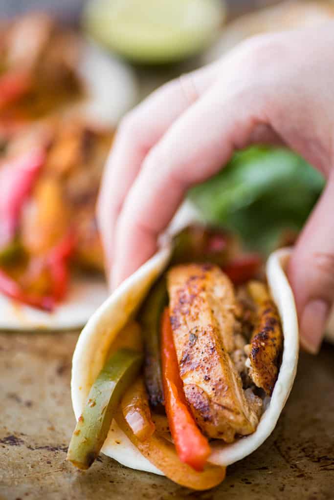 Chicken fajita being picked up.