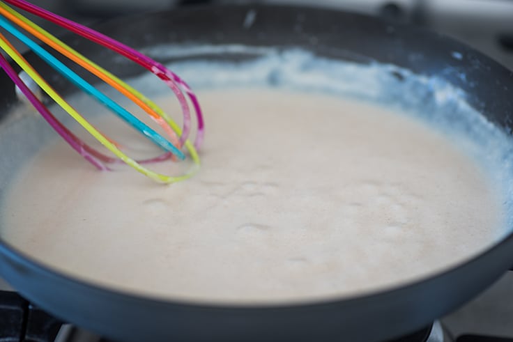 Gravy being whisked on the stove.