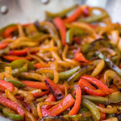 Fajita vegetables in a large skillet.