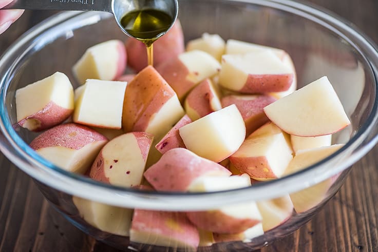Cut red potatoes in a bowl.