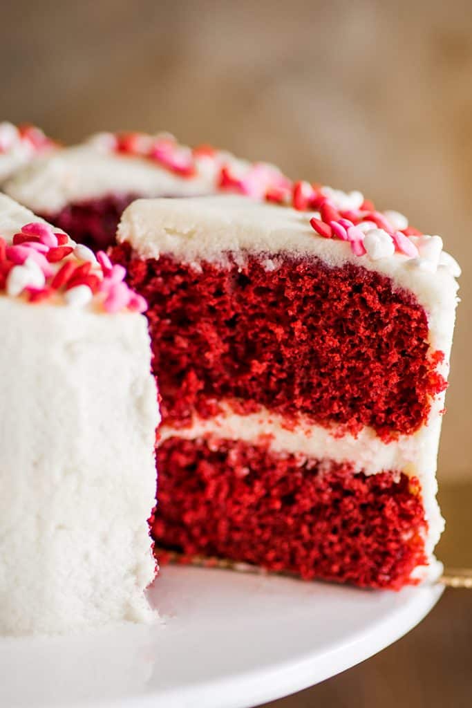 Picture of a slice of six-inch red velvet cake being cut out of the cake.
