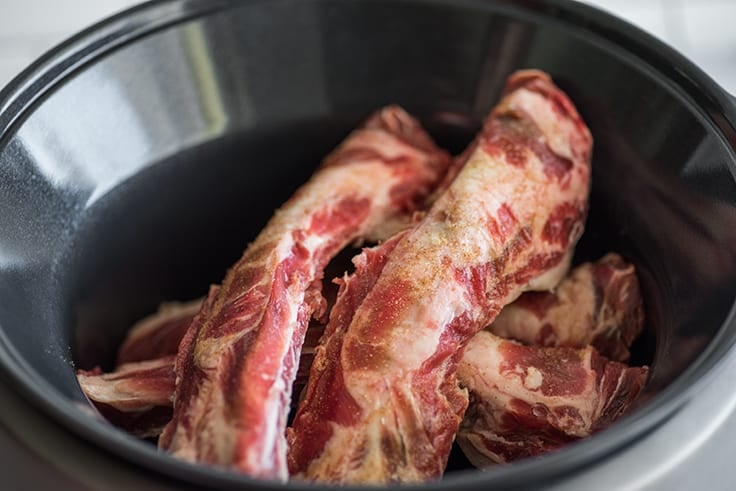 Beef back ribs in a slow cooker.