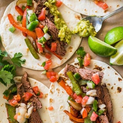 Overhead photo of steak fajitas on parchment paper.
