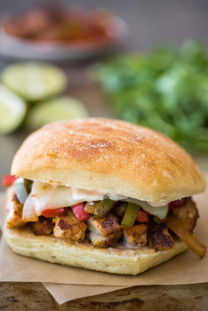 Chicken fajita sandwich on parchment paper.