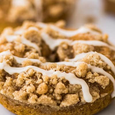 Pumpkin donuts with streusel and glaze drizzle.
