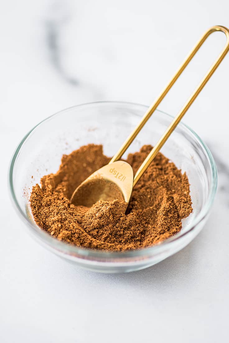 Homemade pumpkin pie spice mix in a glass bowl.