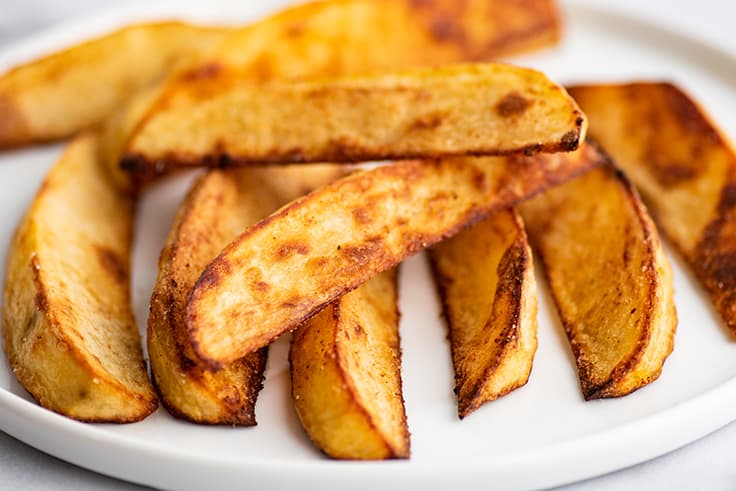 Oven-baked fries on a plate.