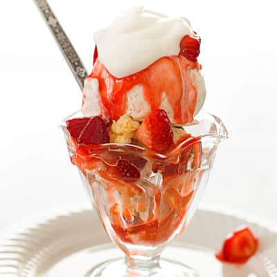 Strawberry shortcake sundae in a glass sundae cup.