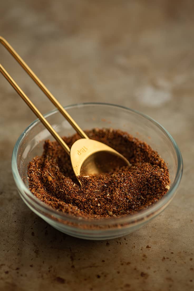 Homemade taco seasoning in a glass bowl.