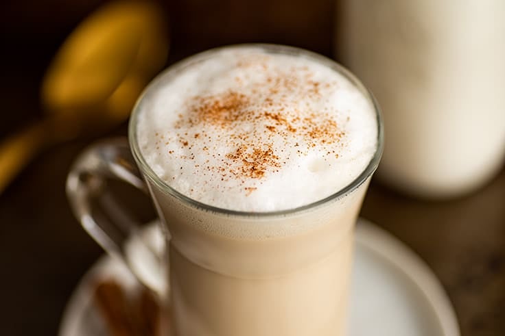 Chai tea latte in a glass mug.
