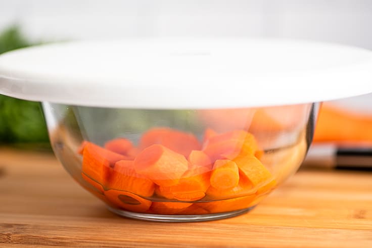 Carrots ready to be microwaved in a bowl.