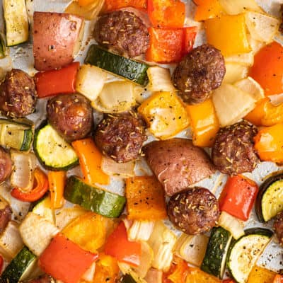 Sausage and vegetables on a sheet pan.