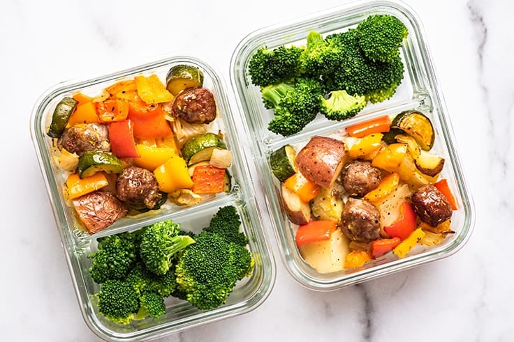Meal prep containers with broccoli and sheet pan sausage and veggies.