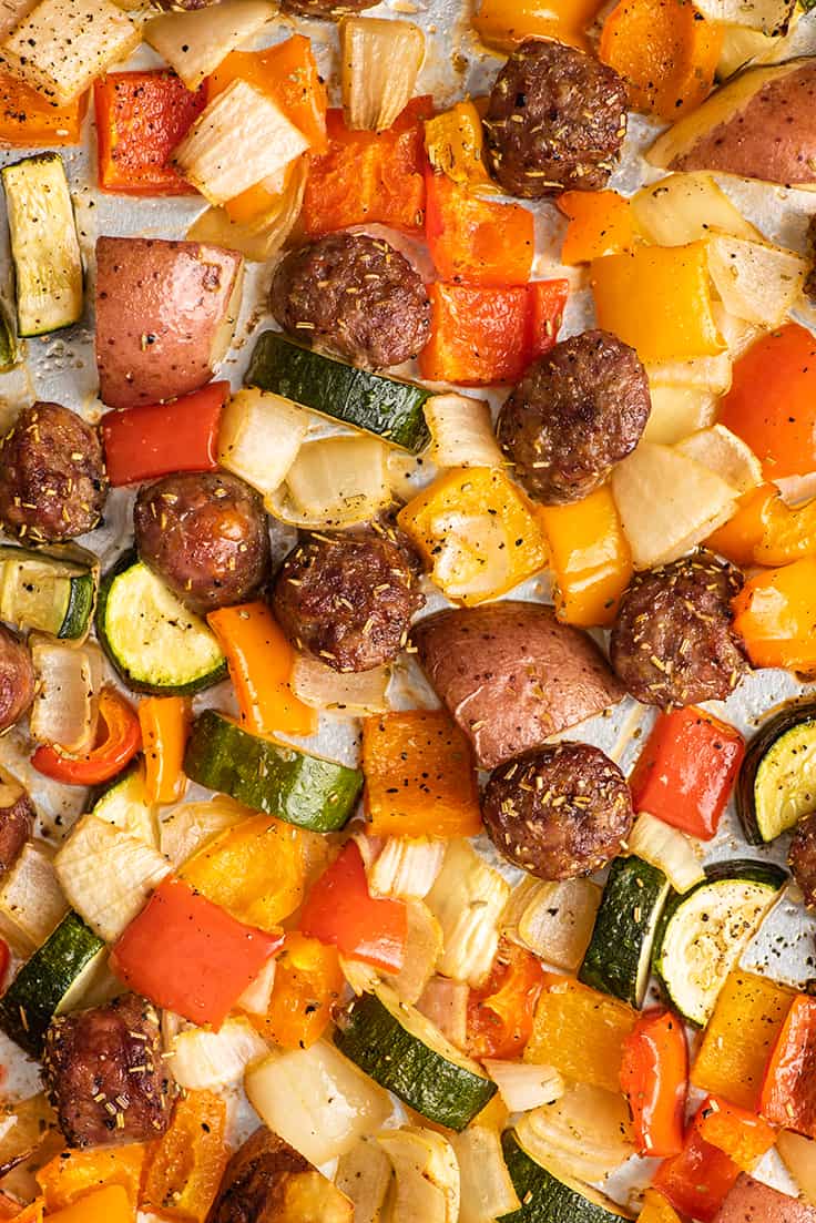 Sausage and vegetables on a sheet pan.