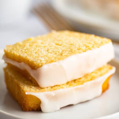 Sliced lemon pound cake on a plate.