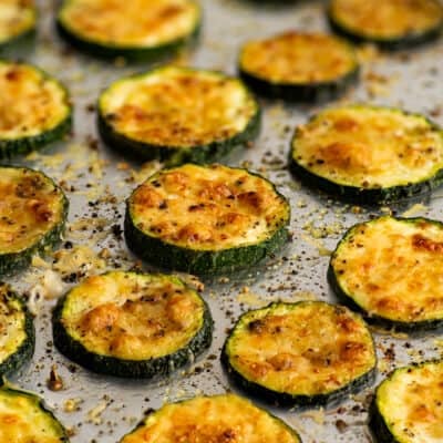 Photo of roasted parmesan zucchini on a baking tray.