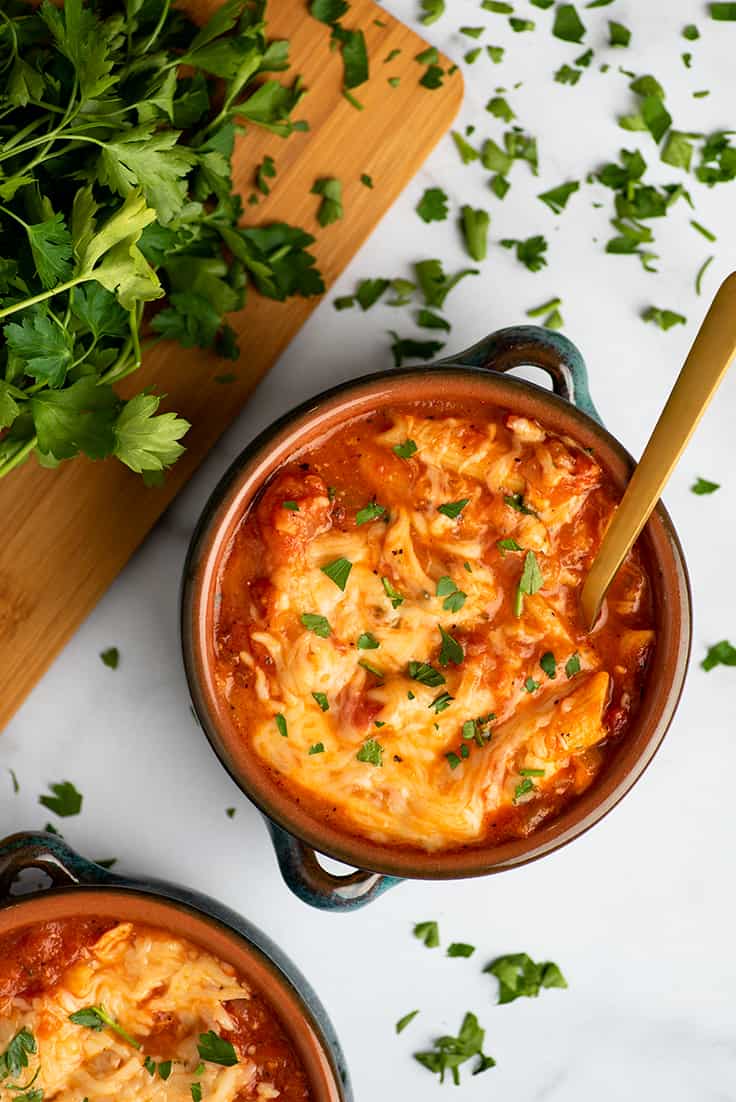 Chicken parmesan soup with parsley.