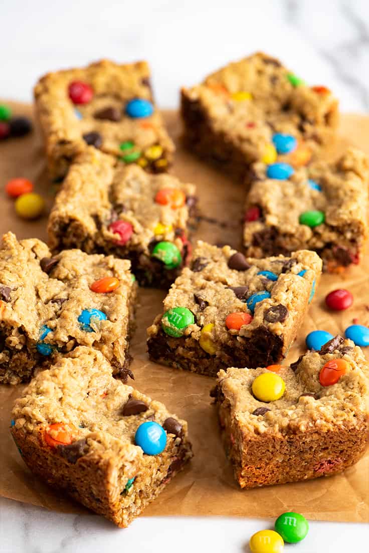 Small-batch monster cookie bars on parchment paper.