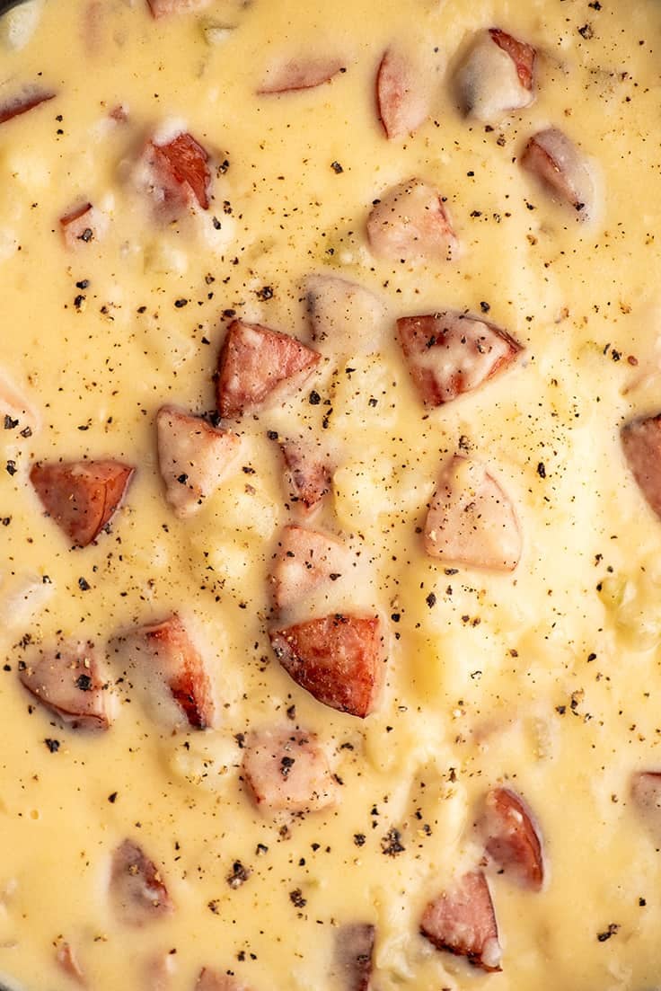 Close up photo of cheesy sausage potato soup.