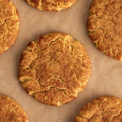 Pumpkin snickerdoodles on parchment paper.