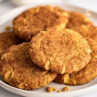 Small-batch pumpkin snickerdoodles piled on a white plate.