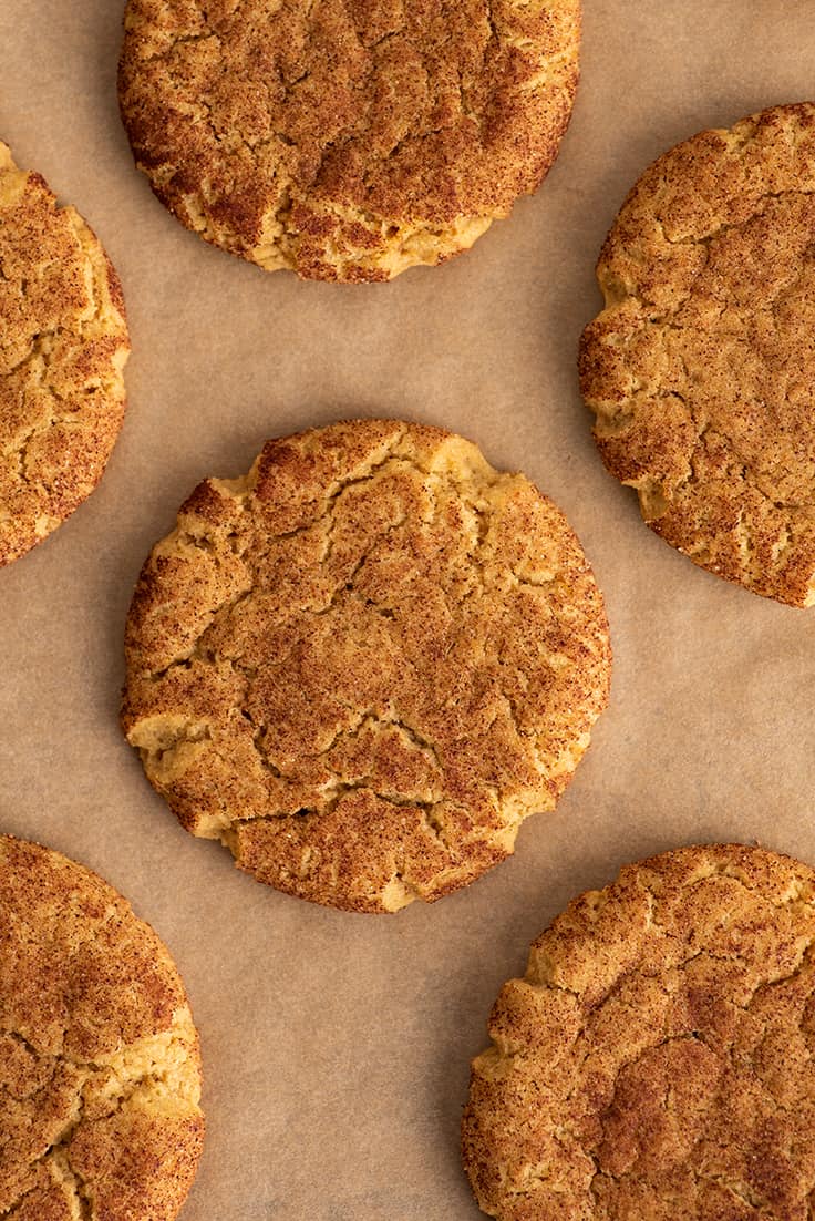 Pumpkin snickerdoodles on parchment paper.