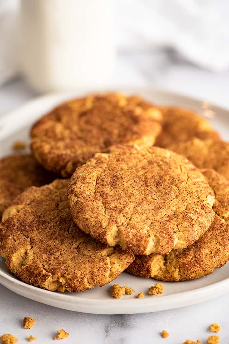Small-batch pumpkin snickerdoodles piled on a white plate.