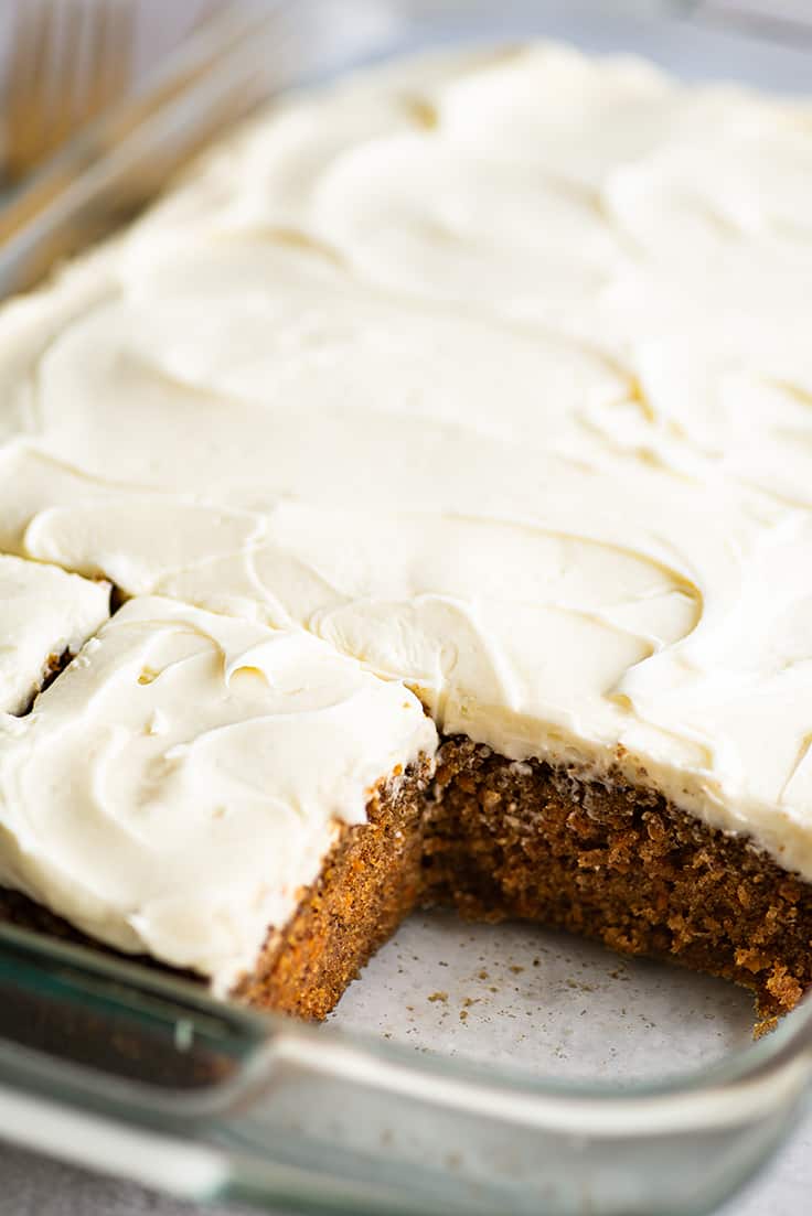 Slices of carrot cake being cut.
