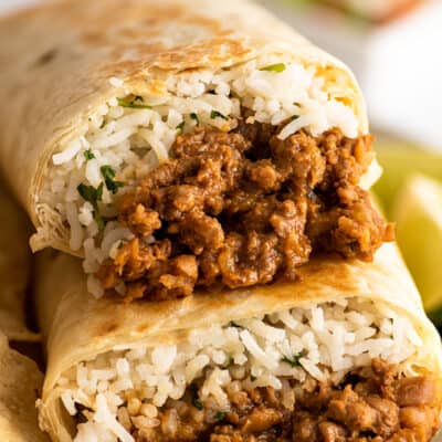 Close up photo of freezer burritos stacked on a plate.