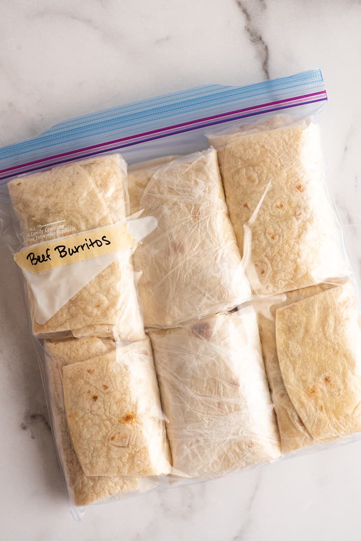 Freezer burritos in a freezer bag ready for freezing.