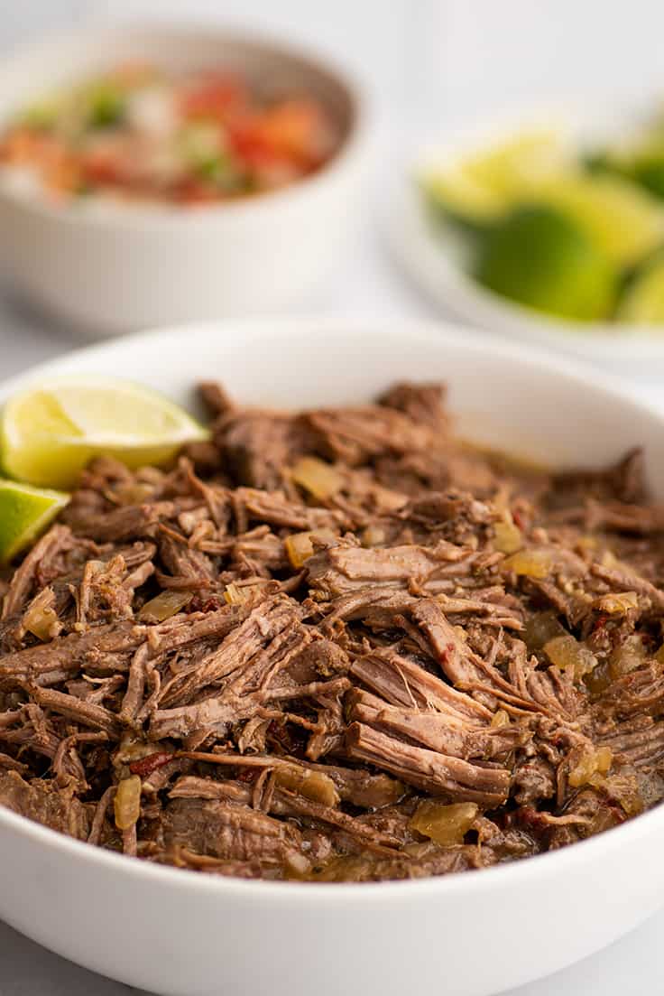 Barbacoa beef in a white bowl.
