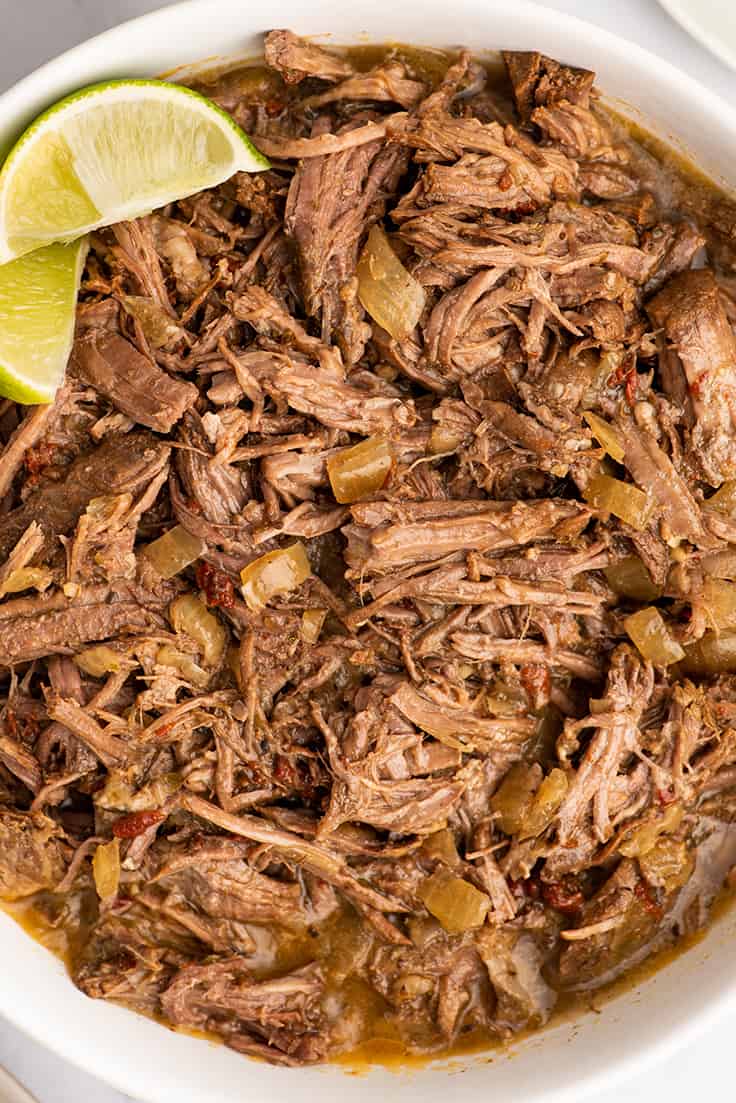 Barbacoa beef shredded for burritos in a bowl.