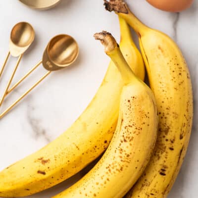 Bananas lying on a marble counter.