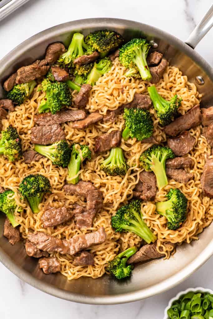 Broccoli beef ramen in a skillet.