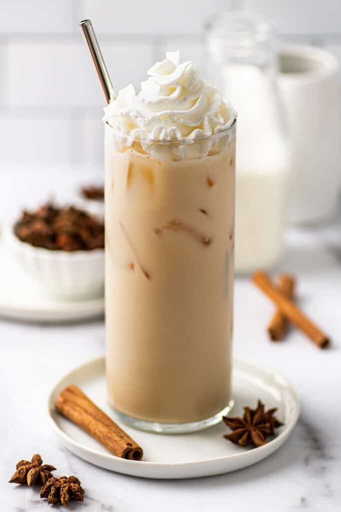 Iced chai tea latte in a glass cup.